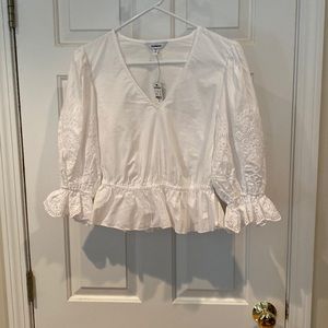 Size XS. White v neck blouse w eyelet detail on 3/4 of the sleeves.  NWT